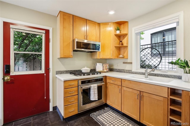 kitchen featuring stainless steel appliances, a sink, open shelves, plenty of natural light, and recessed lighting