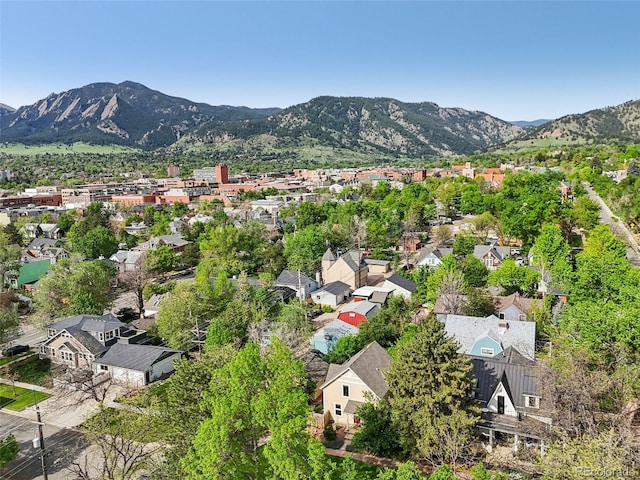 aerial view of property's location featuring mountains and nearby suburban area