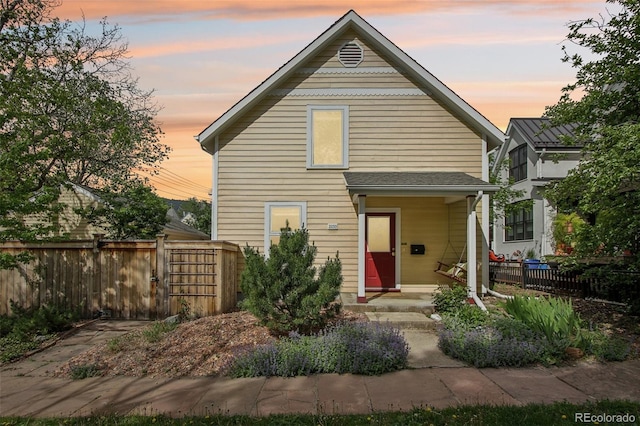 view of front of home featuring fence and a gate