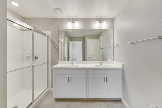 bathroom with a shower with door and vanity