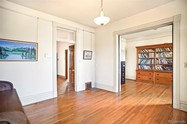 interior space with baseboards and light wood finished floors