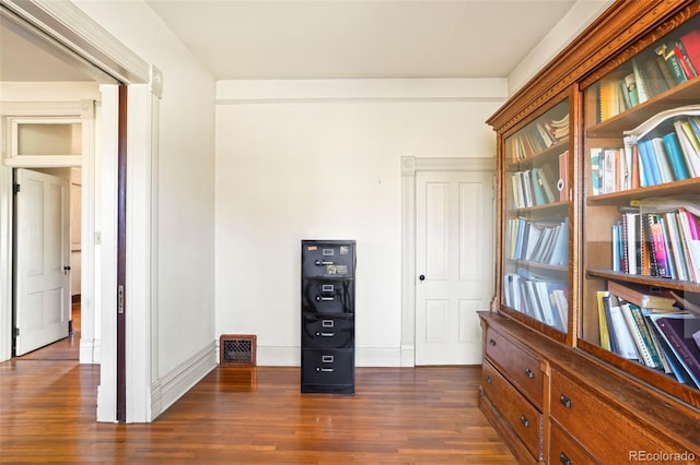 interior space with dark wood-style floors and baseboards