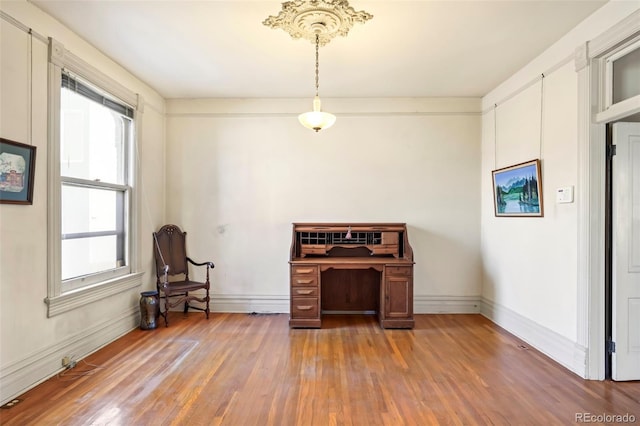 living area with light wood-style flooring and baseboards