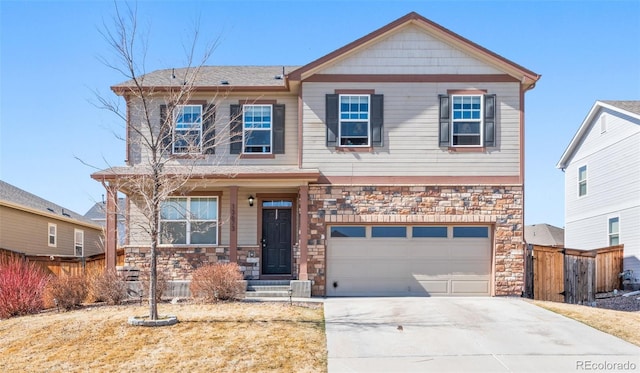 craftsman-style home featuring driveway, stone siding, central AC, fence, and an attached garage