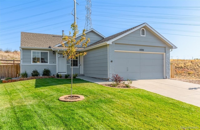 ranch-style house with a garage and a front lawn