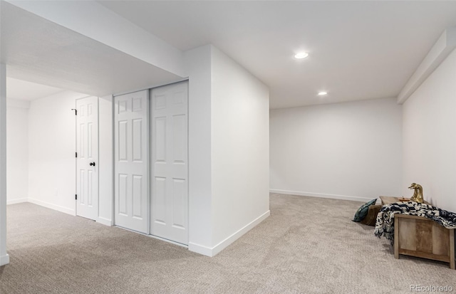 additional living space featuring light carpet