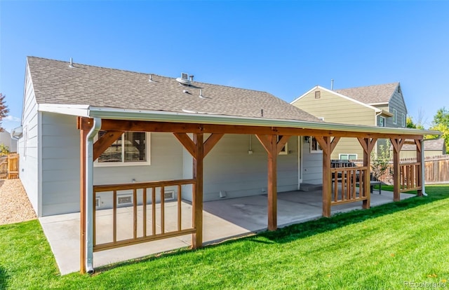 rear view of house featuring a patio area and a yard