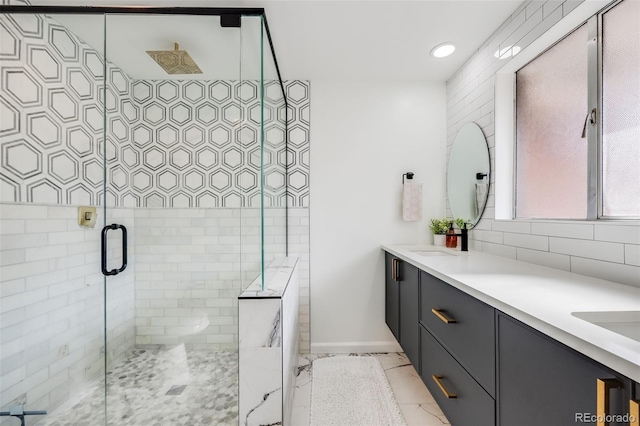 bathroom featuring tasteful backsplash, vanity, and a shower with door