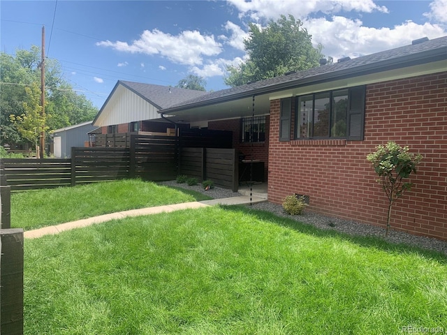 view of side of property with a yard