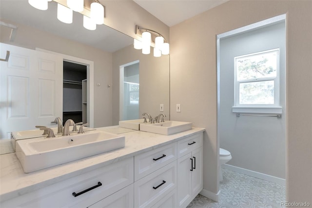 27627 E Broadview Dr, Kiowa, CO 80117 - full bathroom with toilet, baseboards, double vanity, a spacious closet, and a shower