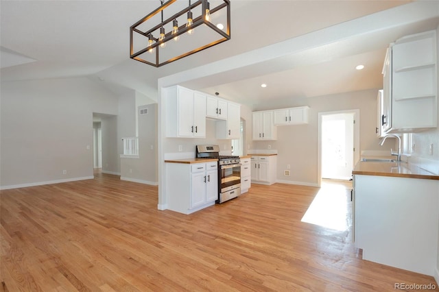 27627 E Broadview Dr, Kiowa, CO 80117 - kitchen with gas stove, a sink, open shelves, light wood-style flooring, and vaulted ceiling