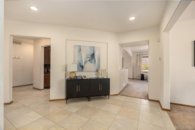 corridor with light carpet, baseboards, visible vents, and recessed lighting