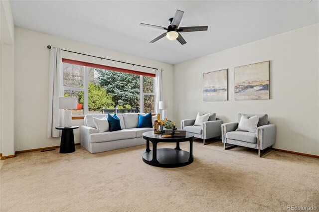 carpeted living room featuring a ceiling fan, visible vents, and baseboards