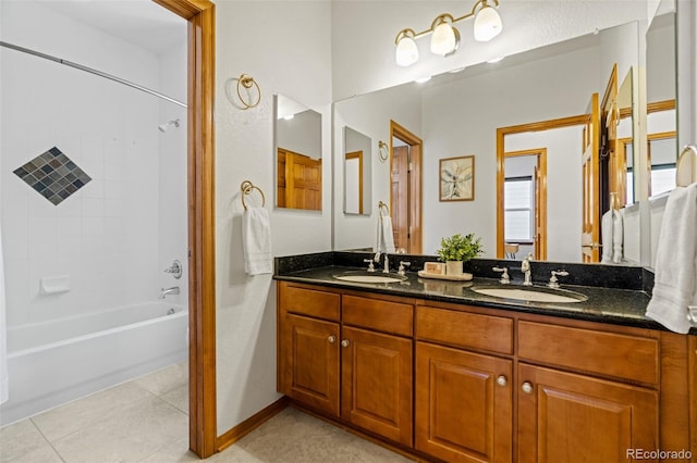 bathroom with double vanity, tile patterned flooring, a sink, and washtub / shower combination