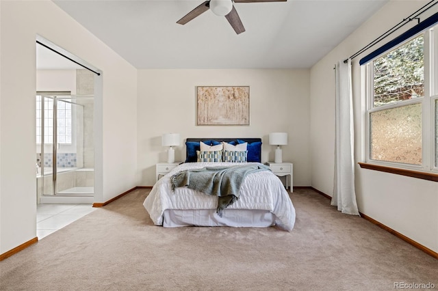 carpeted bedroom with tile patterned flooring, baseboards, a ceiling fan, and ensuite bathroom