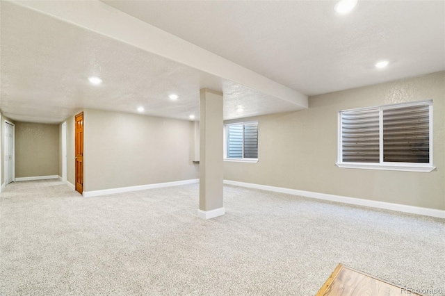 basement featuring carpet floors, recessed lighting, a textured ceiling, and baseboards