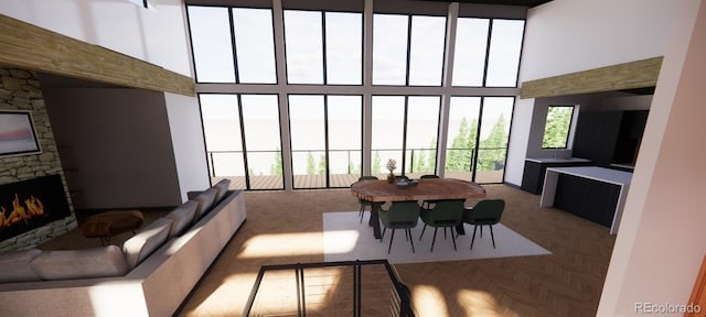 living room featuring a high ceiling and a fireplace