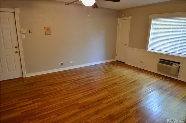 unfurnished room with ceiling fan, a wall mounted AC, and light wood-type flooring