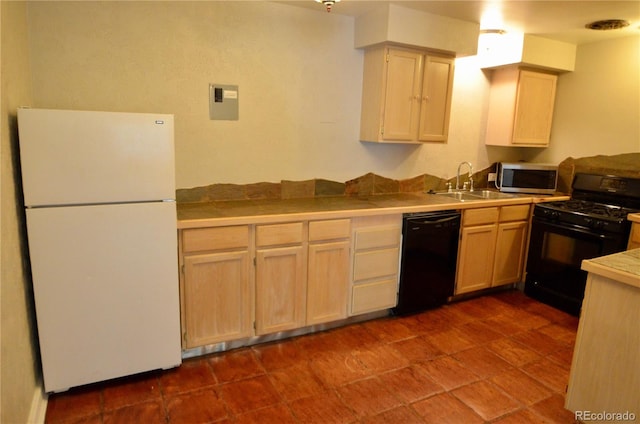 kitchen featuring sink, light brown cabinetry, and black appliances