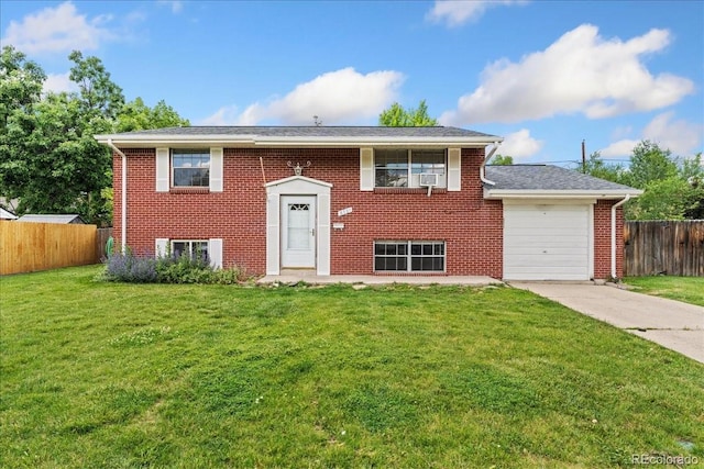 6721 Quay Ct, Arvada, CO 80003 - split foyer home with a garage, brick siding, concrete driveway, and cooling unit