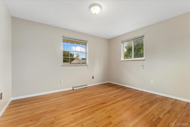 6721 Quay Ct, Arvada, CO 80003 - unfurnished room with plenty of natural light, light wood finished floors, and a baseboard radiator