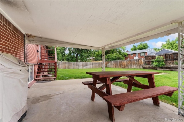 6721 Quay Ct, Arvada, CO 80003 - fenced backyard with stairway, a patio, and outdoor dining area