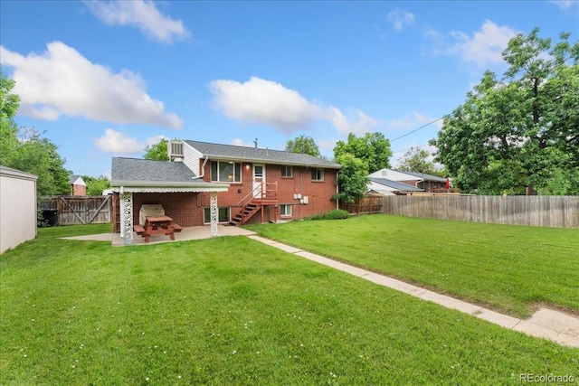 6721 Quay Ct, Arvada, CO 80003 - back of house featuring a patio, a fenced backyard, and brick siding
