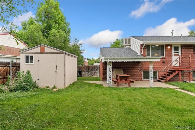 6721 Quay Ct, Arvada, CO 80003 - rear view of house with a patio, a fenced backyard, a shed, and brick siding
