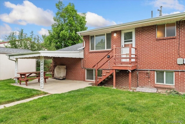 6721 Quay Ct, Arvada, CO 80003 - rear view of house with a lawn, a patio area, brick siding, and roof with shingles
