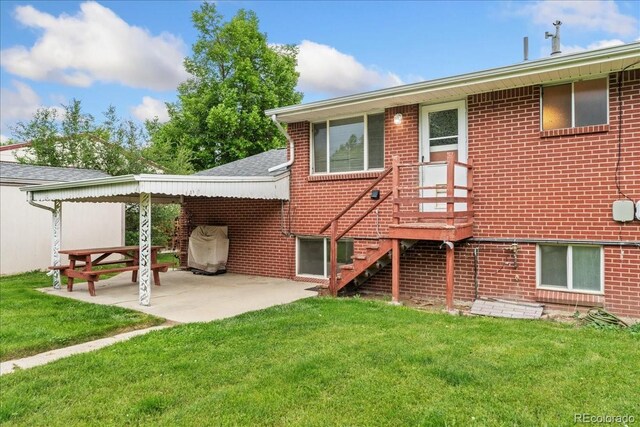 6721 Quay Ct, Arvada, CO 80003 - rear view of house with a lawn, a patio area, brick siding, and roof with shingles