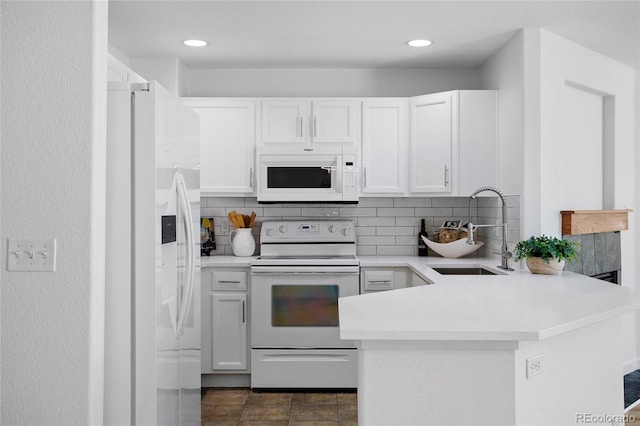 14247 Pikeminnow Pl, Broomfield, CO 80023 - kitchen featuring white appliances, a sink, a peninsula, light countertops, and tasteful backsplash