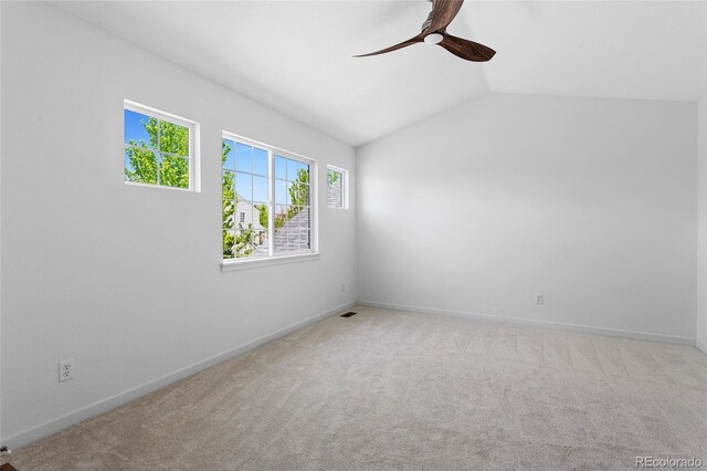 14247 Pikeminnow Pl, Broomfield, CO 80023 - carpeted spare room with a ceiling fan, vaulted ceiling, and baseboards