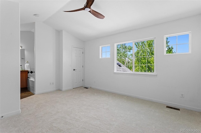 14247 Pikeminnow Pl, Broomfield, CO 80023 - unfurnished bedroom with carpet, lofted ceiling, baseboards, and connected bathroom