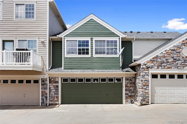 14247 Pikeminnow Pl, Broomfield, CO 80023 - view of front facade with stone siding, an attached garage, and driveway