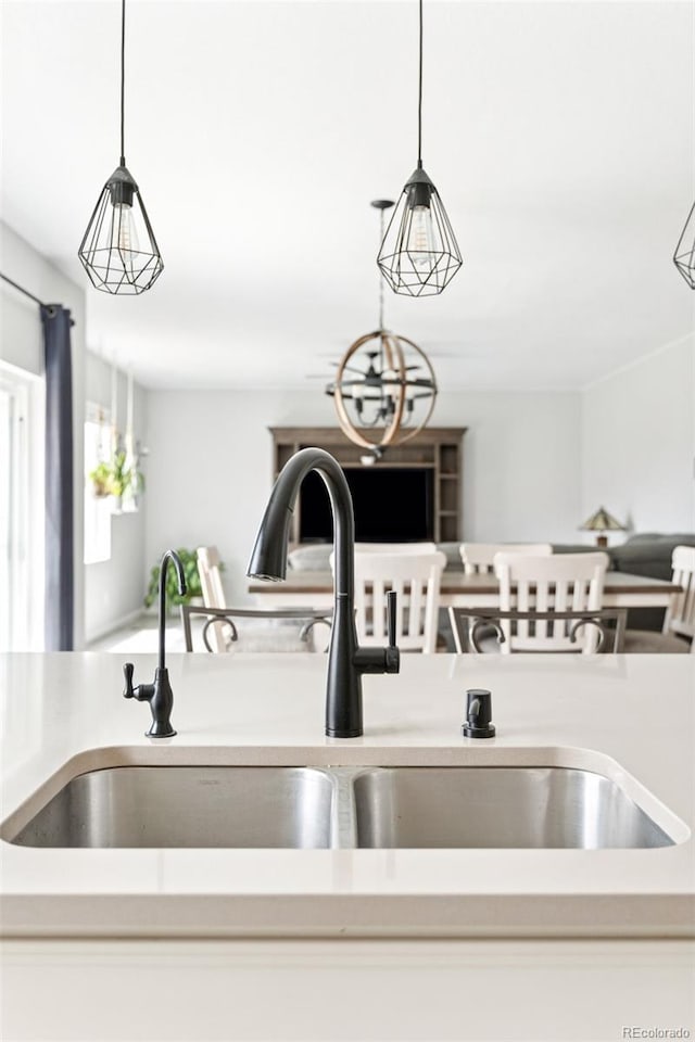 4280 Pioneer Pl, Brighton, CO 80601 - kitchen featuring a sink, decorative light fixtures, and light countertops