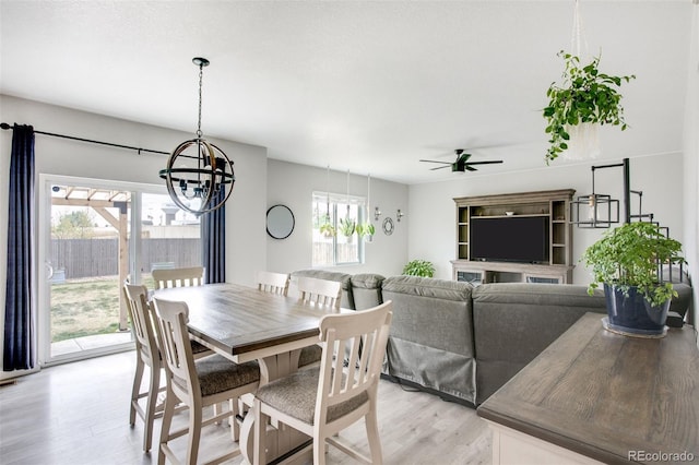 4280 Pioneer Pl, Brighton, CO 80601 - dining space with a chandelier, light wood-style flooring, and a ceiling fan
