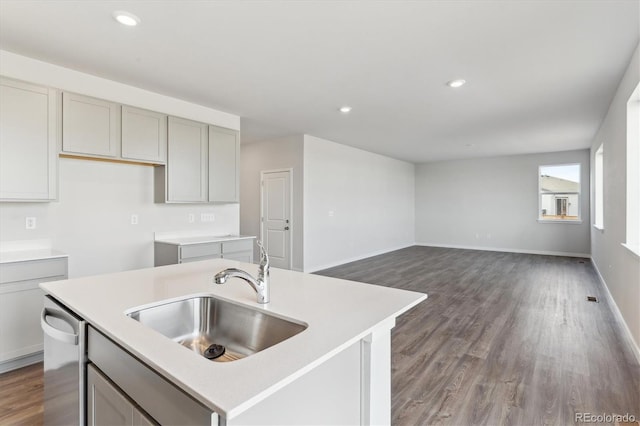 kitchen with gray cabinets, sink, dishwasher, and a kitchen island with sink