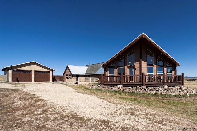 view of side of home featuring a garage and an outbuilding