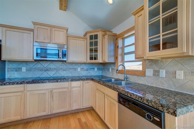 kitchen with sink, light hardwood / wood-style flooring, stainless steel appliances, and tasteful backsplash