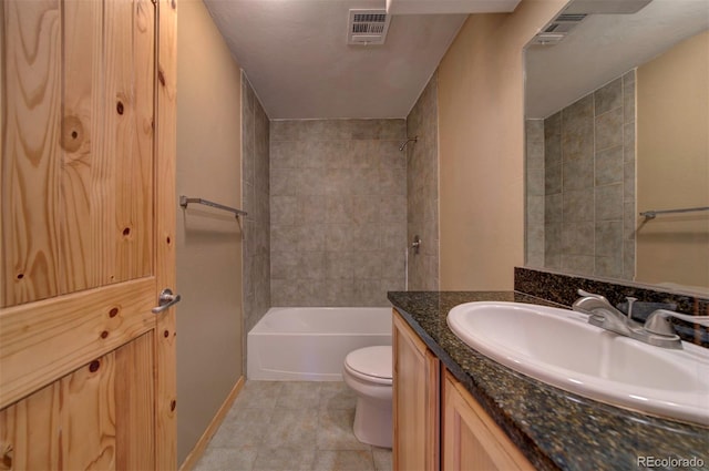 full bathroom featuring vanity, toilet, tile patterned floors, and tiled shower / bath