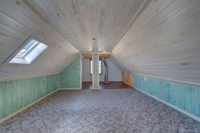 bonus room with vaulted ceiling with skylight, a wealth of natural light, and wooden ceiling