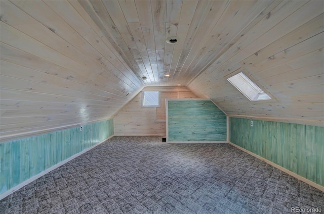 bonus room featuring wooden walls, carpet, wooden ceiling, and lofted ceiling with skylight