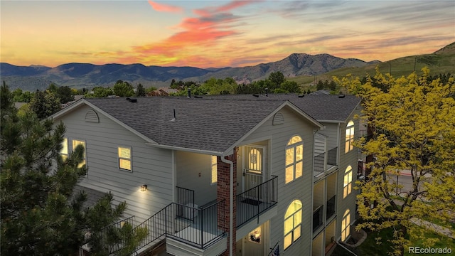 1670 S Deframe St Unit C2, Lakewood, CO 80228 - view of front of home featuring a mountain view, a shingled roof, and a balcony