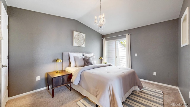1670 S Deframe St Unit C2, Lakewood, CO 80228 - bedroom with a chandelier, vaulted ceiling, light colored carpet, and baseboards