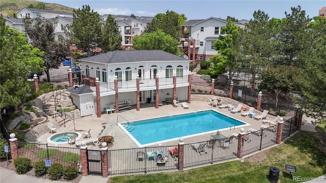 1670 S Deframe St Unit C2, Lakewood, CO 80228 - community pool featuring a patio area, a hot tub, stairway, and a residential view