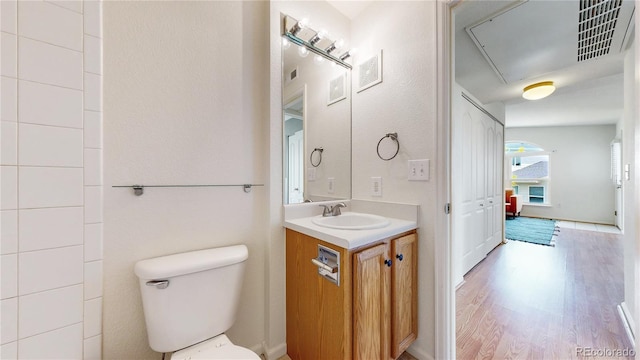 1670 S Deframe St Unit C2, Lakewood, CO 80228 - bathroom featuring vanity, toilet, and wood finished floors