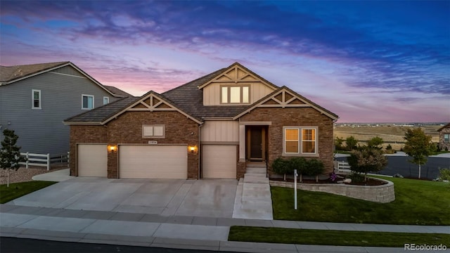 craftsman-style home featuring a garage and a lawn