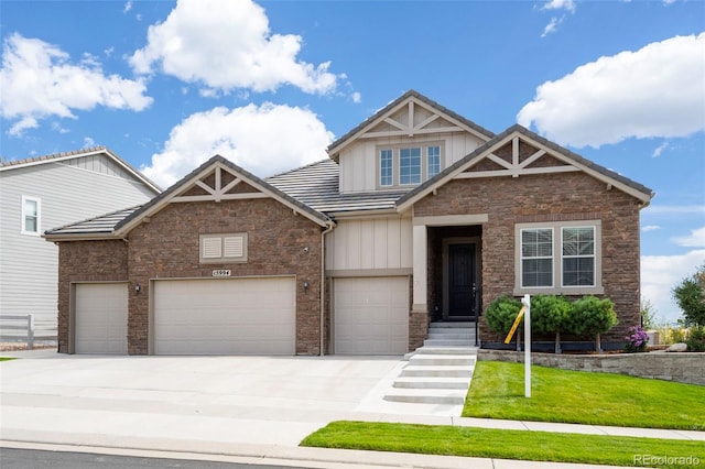 craftsman-style home featuring a front lawn and a garage