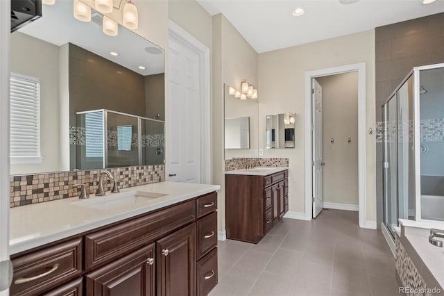 bathroom featuring vanity, walk in shower, tile patterned flooring, and backsplash