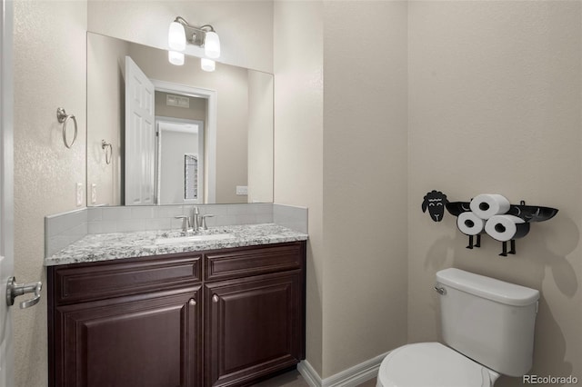 bathroom featuring toilet and vanity